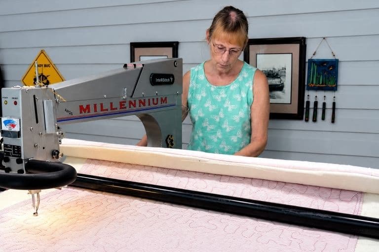 Mary operating a longarm quilting machine at Online Quilting Studio in Ocala, Florida.